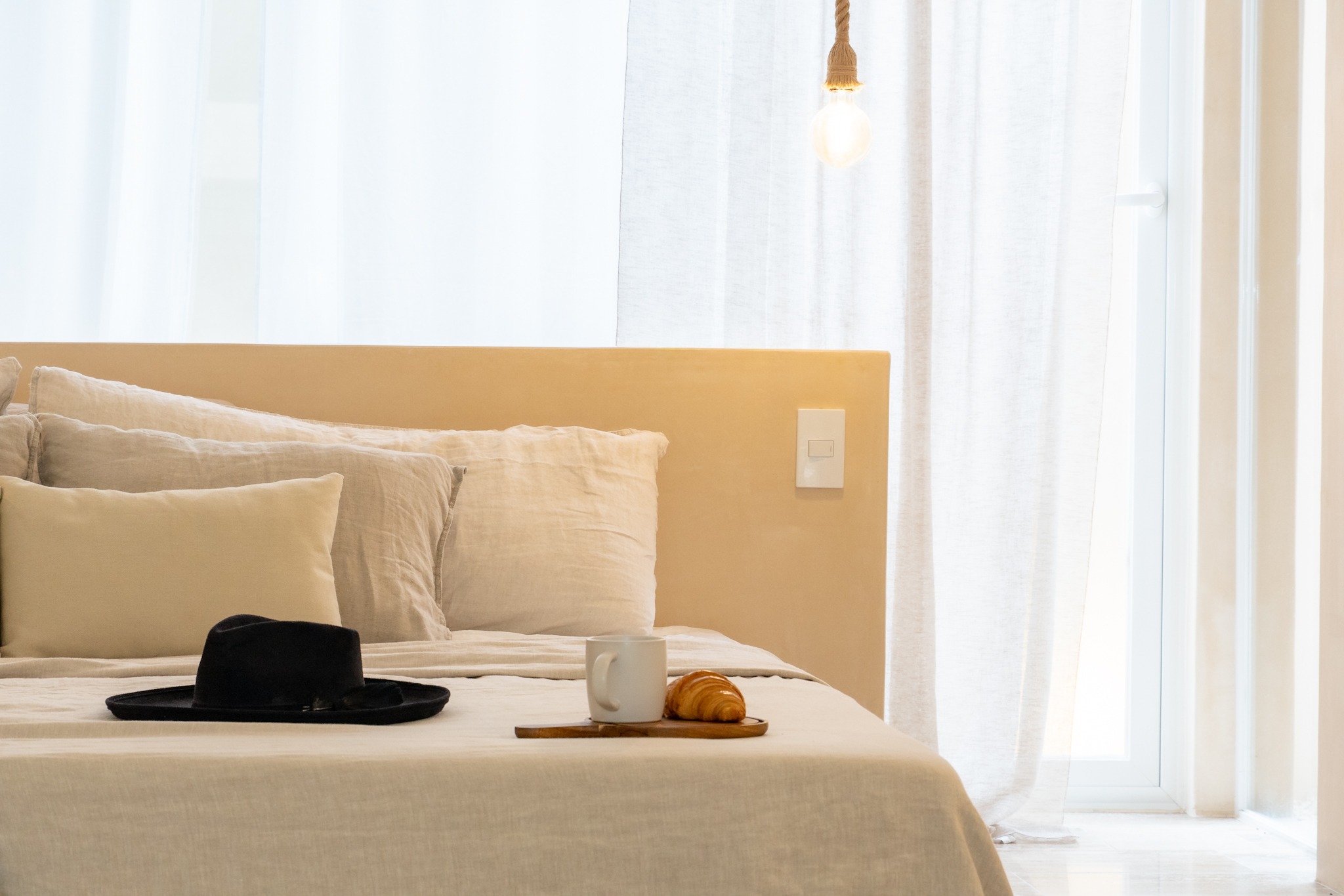 Linen bedding with coffee and a croissant